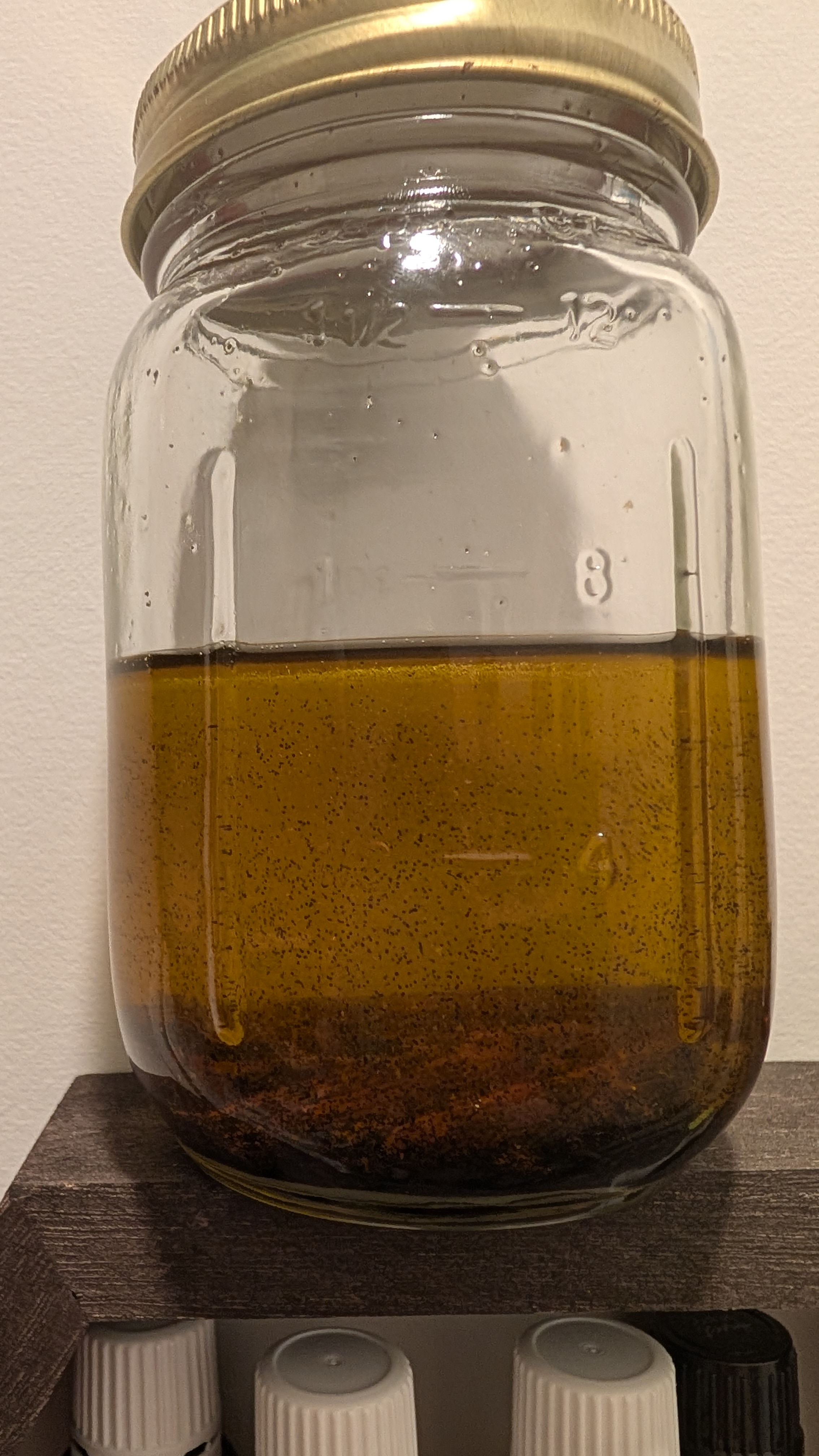Golden vanilla-infused jojoba oil in a mason jar
